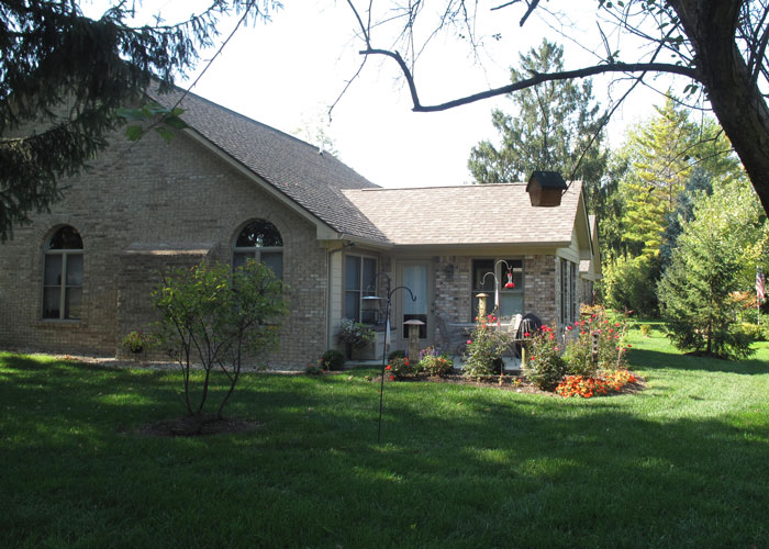 Exterior photo of a private home in Hoosier Village with large shaded yard