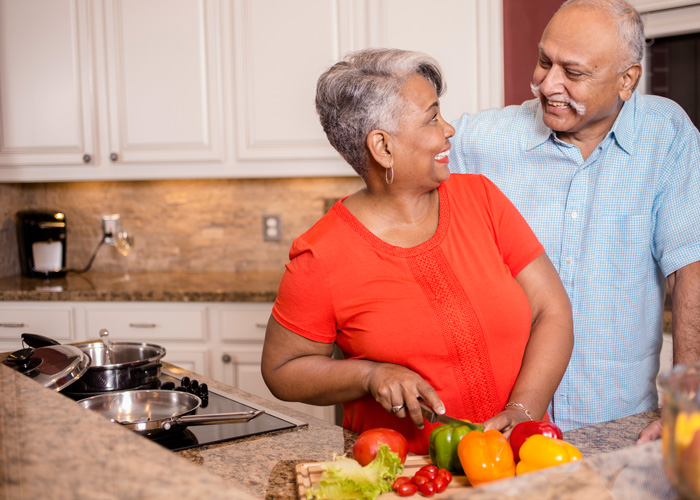 Mature couple converse in kitchen A couple cooking in the kitchen at an apartment at Hoosier Village