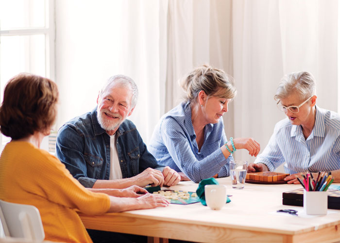 People gathered at a table playing a board game